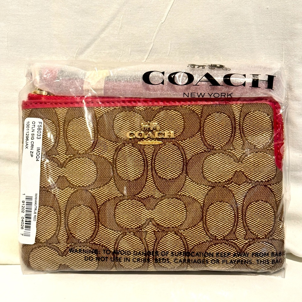 Coach Wristlet with Pink Trim! New With Tag- unopened.